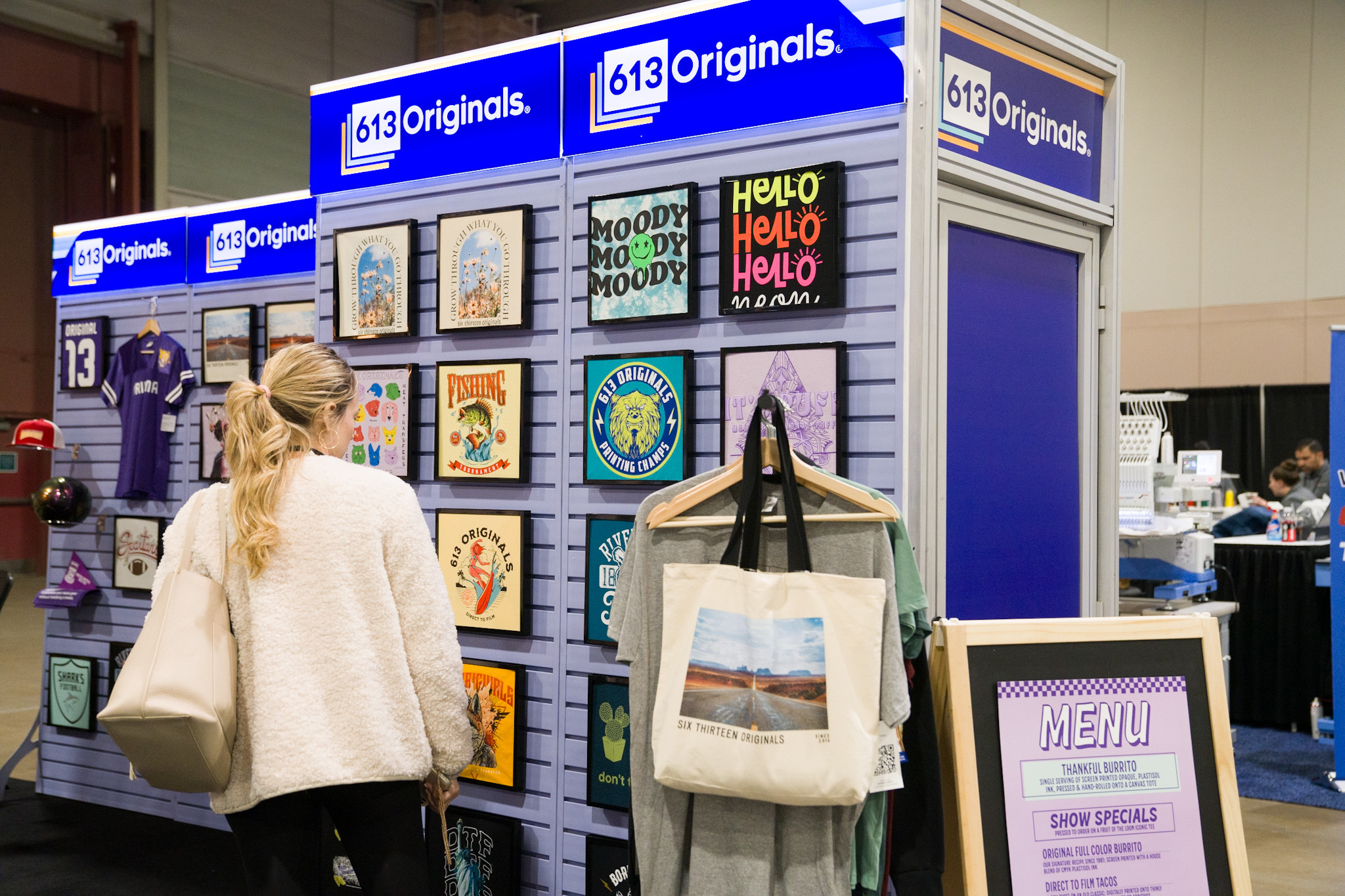 A trade show attendee browses our t-shirt wall at Impressions AC